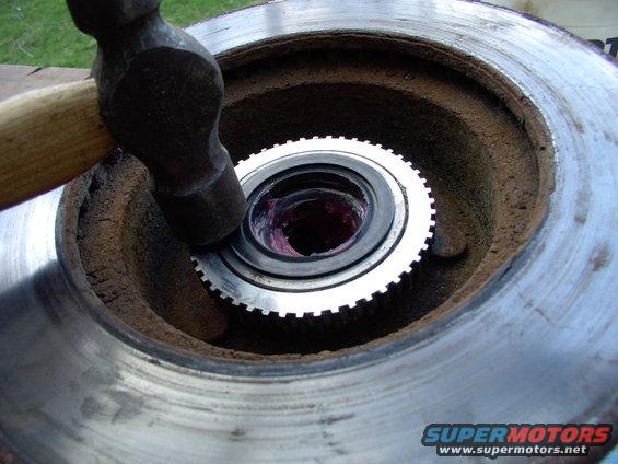 If you can't get the new inner seal to seat like this, place a large rubber mallet over it and pound the mallet with a hammer. That will spread the blows evenly and seat it easily, I find.