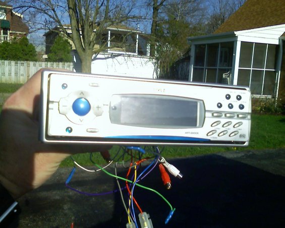 Car stereo with blue button and display, wires attached