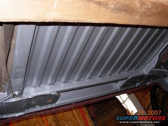 Underside of a vehicle with gray ribbed flooring and wooden beams above. Date stamp reads 04 29 2007