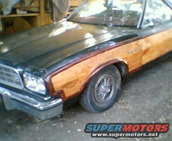 Pickup truck with wood paneling on the side, front quarter view