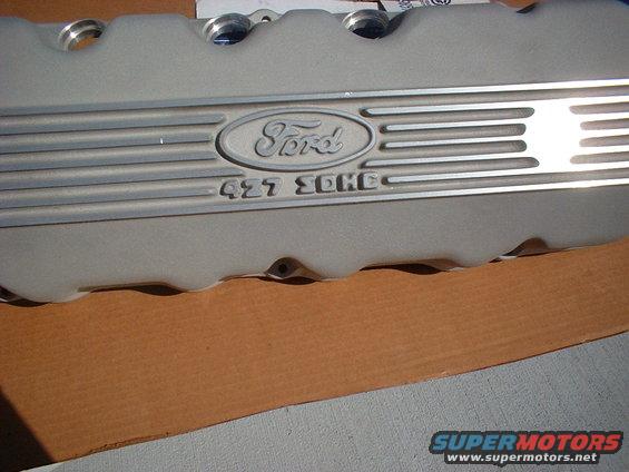 Close-up of a silver Ford valve cover with 'Ford' oval logo and '427 SOHC' text