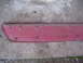 1994 Ford Probe - Red plastic trim piece with mounting clips, likely from a car's exterior.