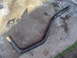 1994 Ford Probe - A black exhaust pipe is shown on a concrete surface, with a discarded can in the background.