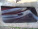1994 Ford Probe - A black interior door panel, likely from a car, is shown lying flat on a concrete surface.