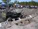 1989 Ford Bronco - A Jeep tackles a challenging off-road course during an event, with a crowd gathered to watch the action.