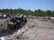 1989 Ford Bronco - Off-road vehicle navigates a challenging dirt course with spectators in the background.