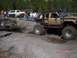 1989 Ford Bronco - Two off-road vehicles are engaged in a tug-of-war in a muddy terrain.