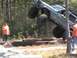 1989 Ford Bronco - An off-road SUV is captured mid-air as it jumps over a series of logs during an event.