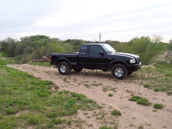 Black 2003 Ford Ranger pickup truck parked on a dirt road
