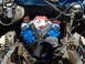 1995 Ford Bronco - The engine compartment shows a freshly painted blue V8 engine with a large fan in front.