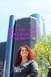 1996 Ford Probe - Woman poses in front of skyscrapers with a humorous text overlay about go-karts.