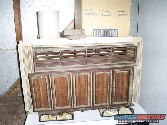 Window air conditioner unit with wood-grain paneling and horizontal vents