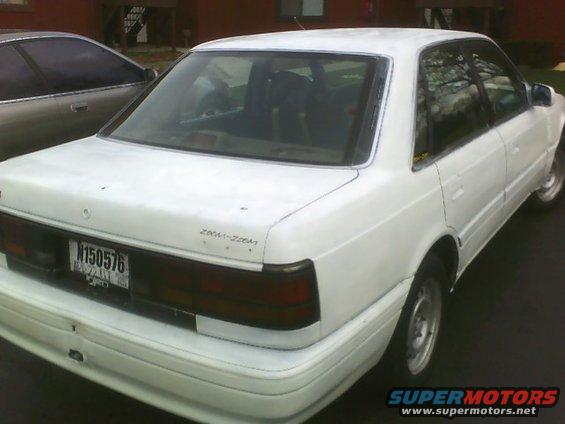 White sedan parked next to another car. License plate N150576 is visible