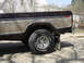 1979 Ford Bronco - This image shows the side profile of a vintage pickup truck, focusing on the rear wheel and lower body panel.