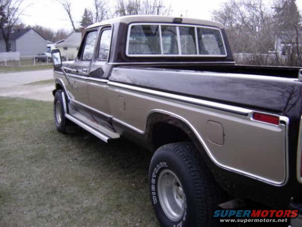 Two-tone pickup truck, side view. Chrome trim, running boards, and silver wheels