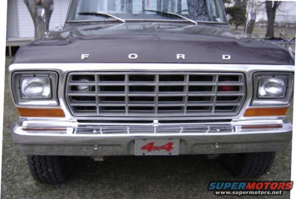 Front view of a 1979 Ford Bronco with a chrome grille and a 4x4 badge on the bumper