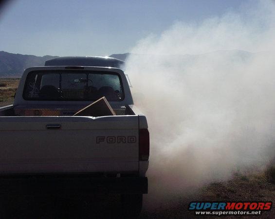 Rear view of 1997 Ford F-250 emitting heavy white smoke