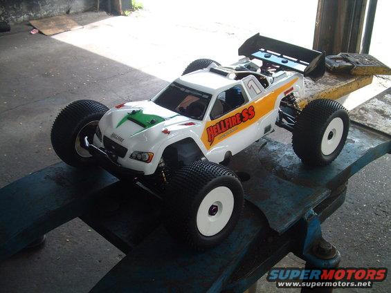 White RC buggy with orange and yellow 'Hellfire SS' graphics, number 1 on roof