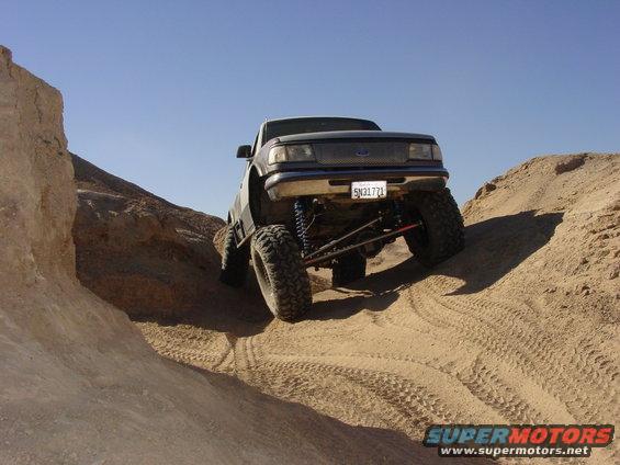 Lifted 1997 Ford Ranger climbing sandy hill, California license plate 5N31771