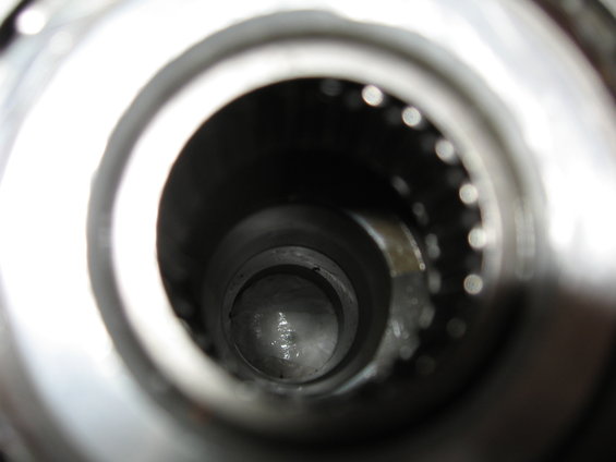Close-up view inside a metal tube showing a bearing race