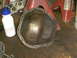 2005 Ford Excursion - Differential cover shown on a workbench, next to a water bottle and red jack stands. The registry claims it is from a 2005 Ford Excursion.