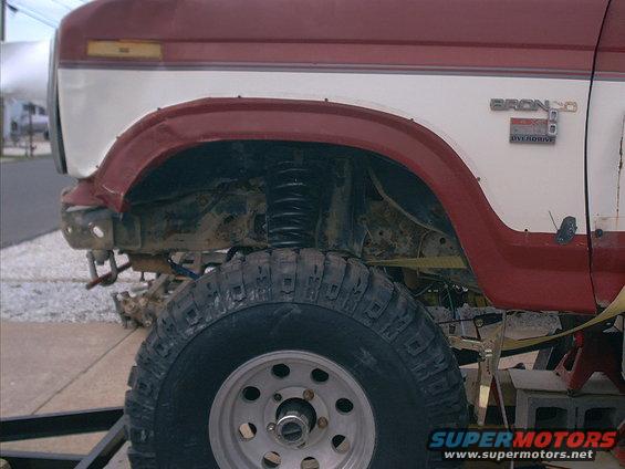 Side view of a 1986 Ford Bronco with lifted suspension and large tires