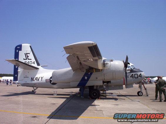 US Navy E-1 Tracer plane with wings folded up, marked 'JE 6404' and '404'