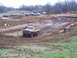 2001 Dodge 1500 - Trucks navigate a muddy off-road course during a race event.