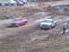 2001 Dodge 1500 - Pickup trucks compete in a mud race event on a dirt track.