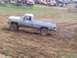 2001 Dodge 1500 - A silver pickup truck navigates a muddy track during an event.