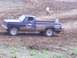 2001 Dodge 1500 - A pickup truck navigates a muddy track during a race event.
