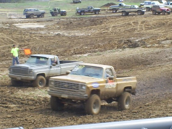 Gold pickup truck with racing decals in mud race