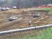 2001 Dodge 1500 - Two pickup trucks navigate a muddy track during a race event.