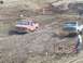 2001 Dodge 1500 - Two pickup trucks navigate a challenging mud course during an event.
