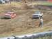 2001 Dodge 1500 - Two pickup trucks compete in a mud race, with spectators watching from the sidelines.