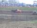 2001 Dodge 1500 - Pickup trucks compete in a mud race with spectators watching from the sidelines.