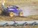 2001 Dodge 1500 - A modified off-road vehicle navigates a muddy track during an event.