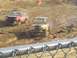2001 Dodge 1500 - Two trucks navigate a muddy course during a race event.