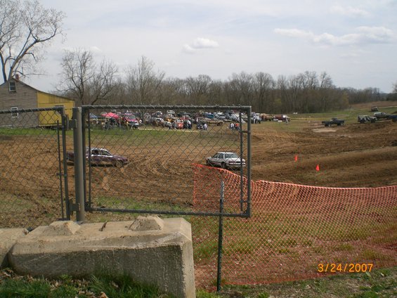 Mud race scene with vehicles on a dirt track, date stamp 3/24/2007