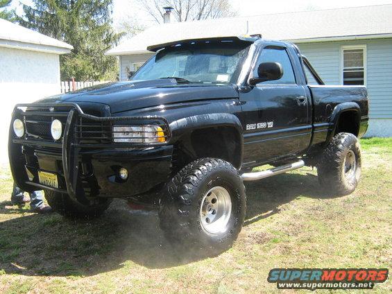 Black lifted Dodge Ram 1500 pickup truck with bull bar and aftermarket wheels
