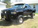 1990 Ford Bronco - This lifted Dodge Ram 1500 pickup truck features a bull bar and custom wheels.