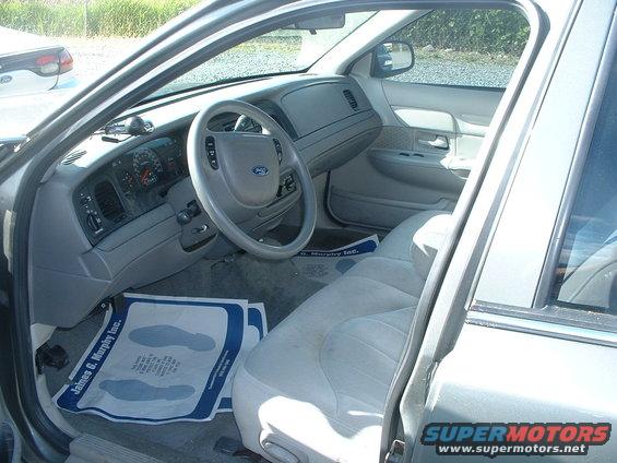 2000 Ford Crown Victoria interior, light gray seats and dashboard, driver's side view