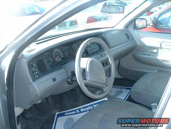 Interior view of a 2000 Ford Crown Victoria, showing the dashboard, steering wheel, and seats
