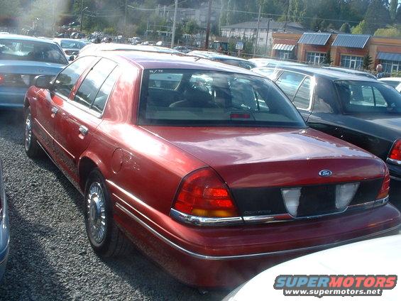 Red sedan, rear view. 2000 Ford Crown Victoria