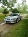 1999 Ford Mustang - Silver 1999 Ford Mustang coupe sits on a dirt road surrounded by greenery.