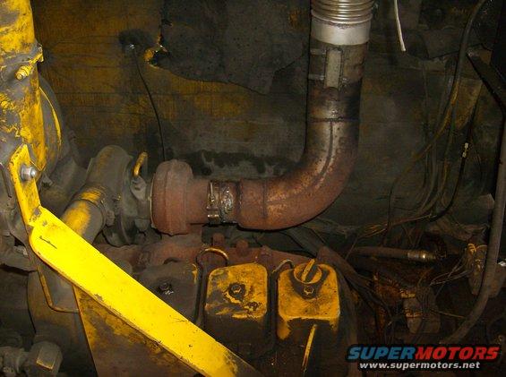 Engine with turbocharger and rusty exhaust pipe