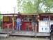 1992 Ford Bronco - A red food stand with a wooden deck serves customers on a sunny day.