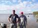 1992 Ford Bronco - Two men pose for a photo on a wooden pier with a wide expanse of water and a distant tree line.