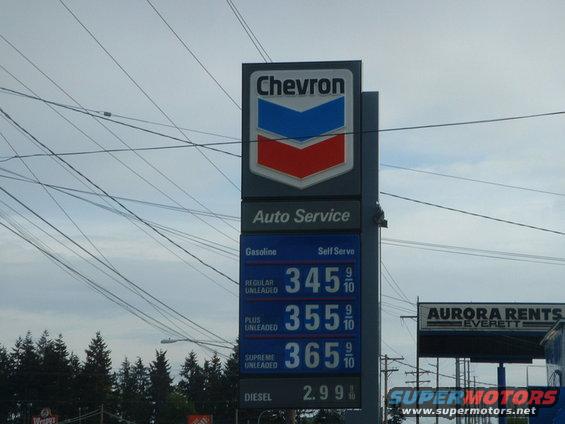Chevron gas station sign with prices for regular, plus, supreme unleaded, and diesel. Also shows "Auto Service" and "Self Serve"