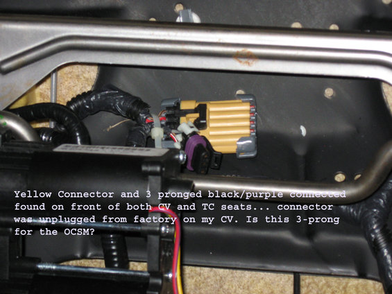 Close-up of yellow and purple electrical connectors under a car seat